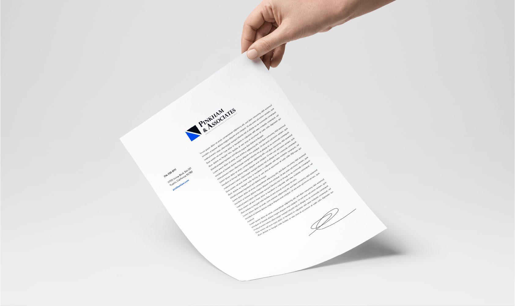 A hand holds a letter printed on white paper featuring the logo and name Pennman & Associates at the top left, with a block of text and a signature at the bottom, all against a plain white background.